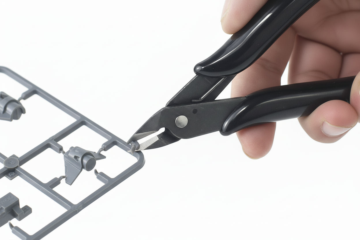 Black wire cutters being used to cut wires with text on a white background